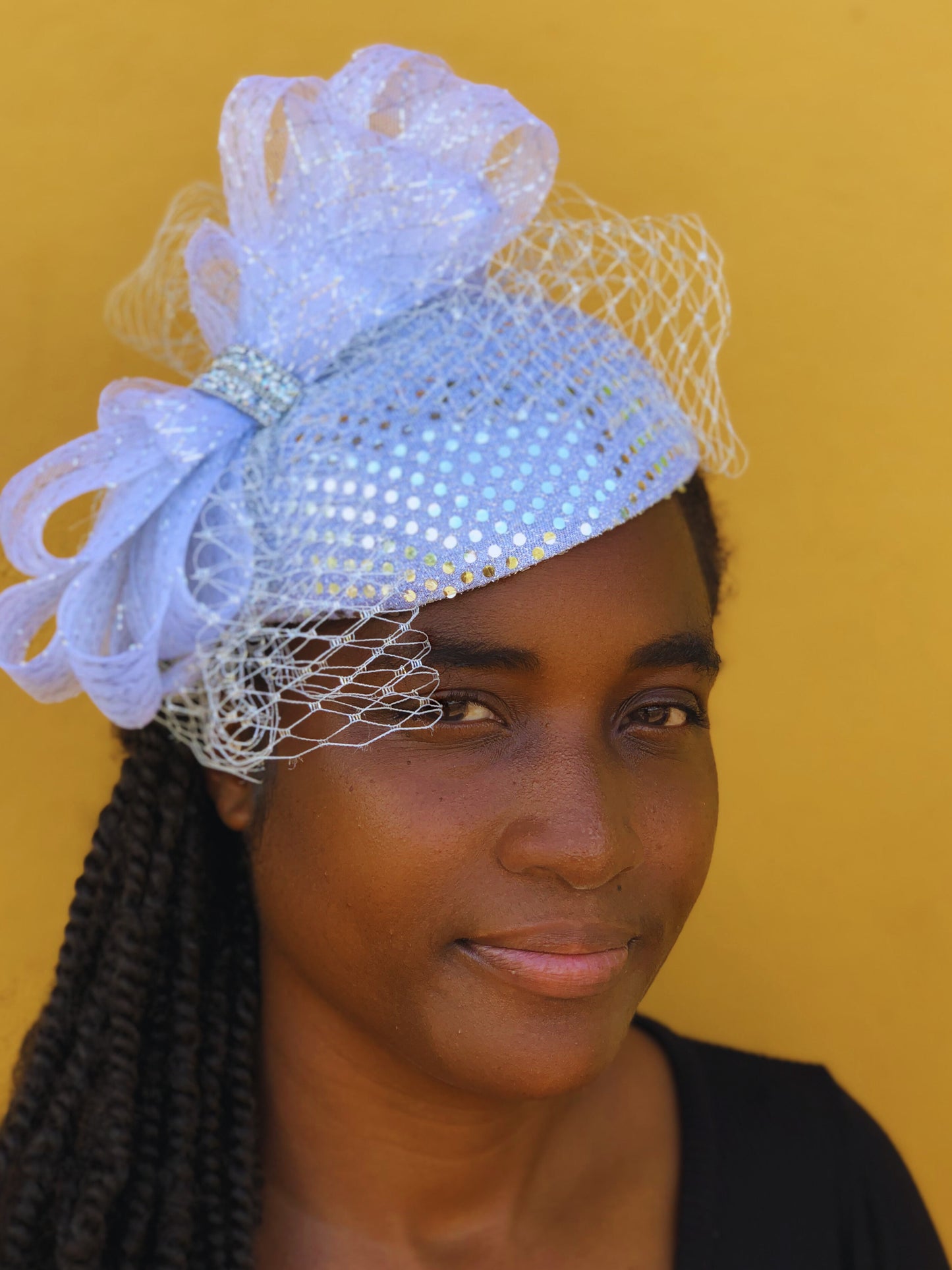 Woman wearing a decorative headpiece with a yellow background