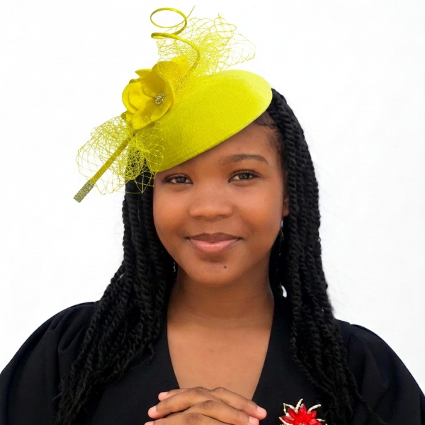 Woman wearing a bright yellow fascinator with decorative feathers on a white background