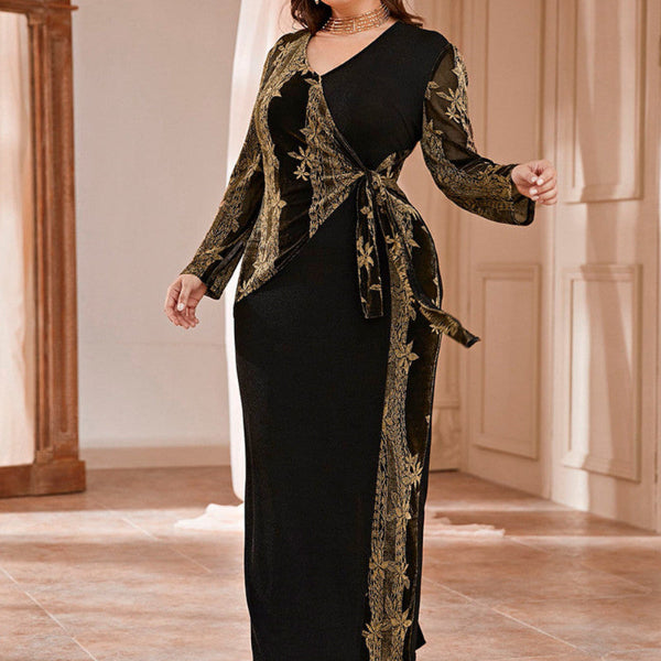 Woman wearing a black dress with gold embroidery in an indoor setting