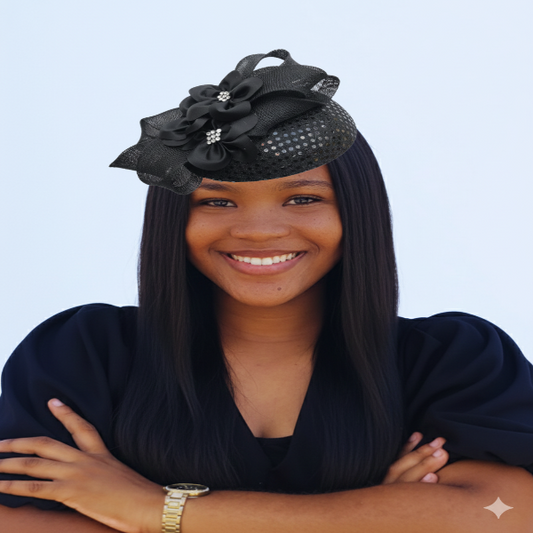 Woman wearing a black fascinator with flowers on a white background