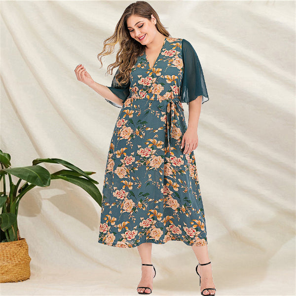 Woman wearing a floral dress with a plain background