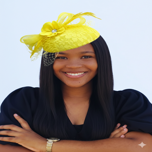 Woman smiling, wearing a bright yellow lace fascinator trimmed with loops, netting, a yellow flower, and feathers.