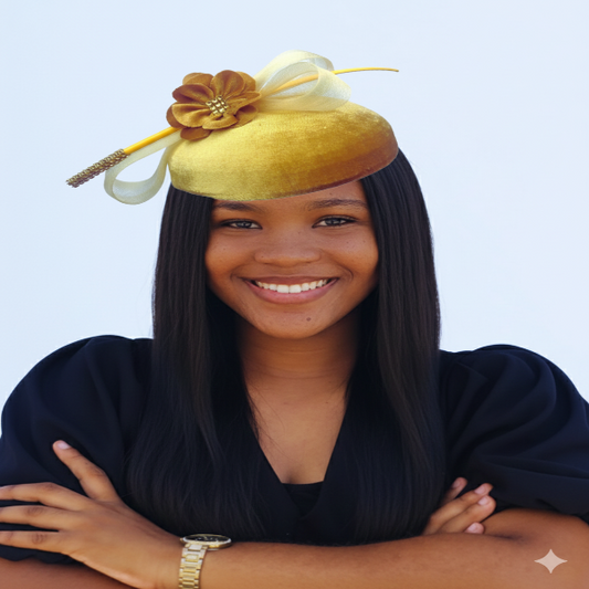 Woman wearing a yellow fascinator with a flower on a light blue background
