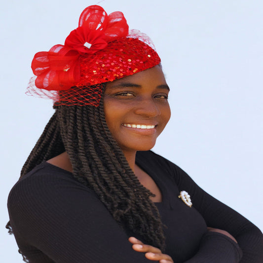 Red sequin fascinator with mesh bow, flower detail, and netting – elegant women’s church hat.