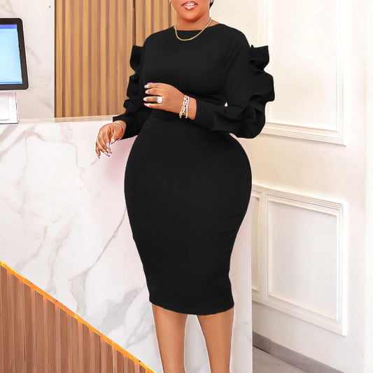 Woman wearing a black dress in an indoor setting