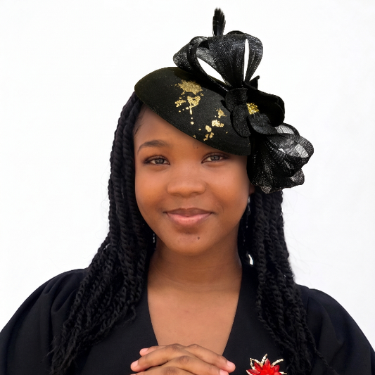 Woman wearing a black headpiece with flowers and a black top with a red flower design.