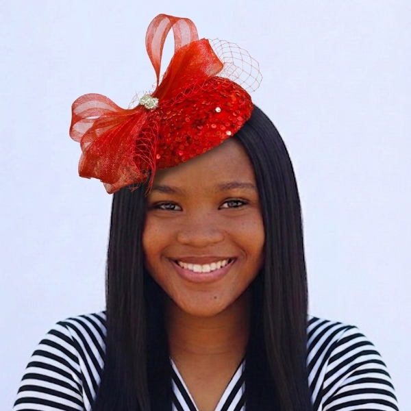 Woman wearing a red headpiece with a white background