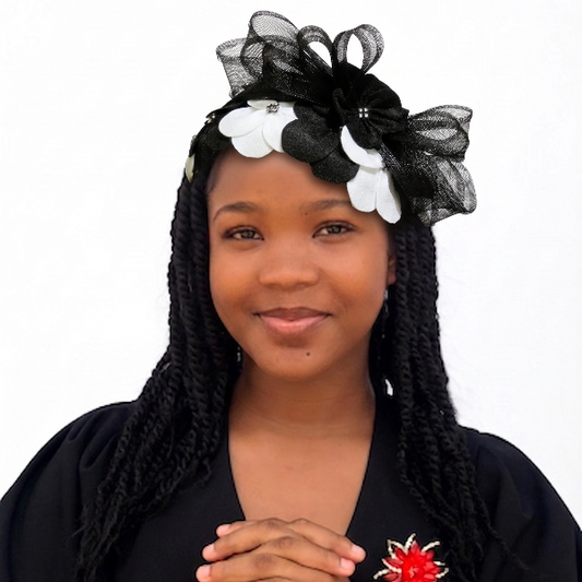 Woman with braided hair wearing a black headband with flowers on a white background