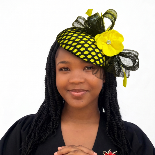 Woman wearing a decorative headpiece with a yellow flower and black mesh, against a white background.