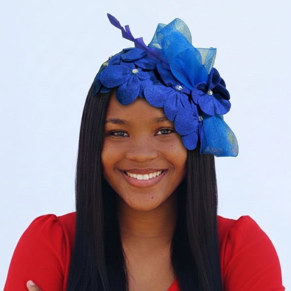 Woman wearing a blue floral headpiece against a light blue background