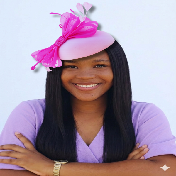 Woman wearing a pink hat with a large pink bow against a light blue background